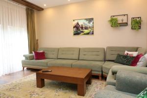 a living room with a couch and a coffee table at Sharr Mount in Prizren