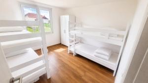 a room with white bunk beds and a window at Šumadijski Pogled in Pružatovac