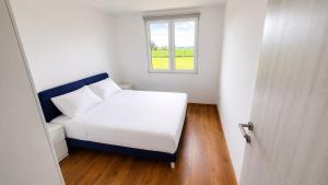 a small bedroom with a bed and a window at Šumadijski Pogled in Pružatovac
