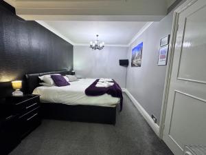 a bedroom with a bed and a chandelier at Verve Hotel in Bedford +82 photos