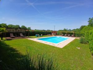 a swimming pool in the middle of a yard at La Vieille Fromagerie in Brux +10 photos