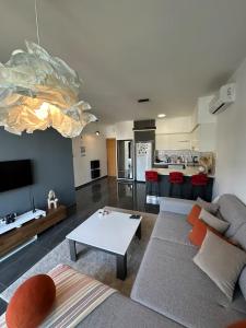 a living room with a couch and a table at Hunz Homes in Ayii Trimithias