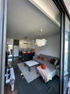 a living room with a couch and a table at Hunz Homes in Ayii Trimithias
