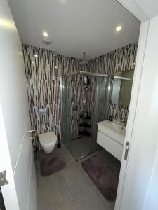 a bathroom with a shower and a toilet and a sink at Hunz Homes in Ayii Trimithias +7 photos