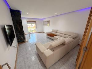 a living room with a couch and a table at Moinho do vento in Nazaré