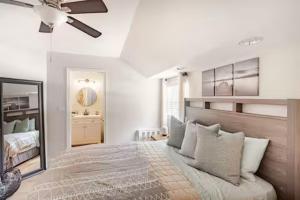 a bedroom with a large bed and a mirror at Sandy Pines Perch - Your Indian River Dock Life Base Camp in Sebastian