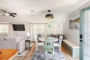 a living room with a table and a couch at Sandy Pines Perch - Your Indian River Dock Life Base Camp in Sebastian +8 photos