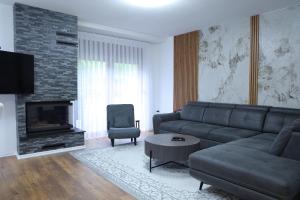 a living room with a couch and a fireplace at Sharr Mount in Prizren