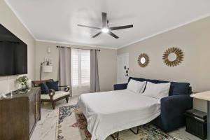 a bedroom with a bed and a ceiling fan at Newly Renovated Condo in Christiansted