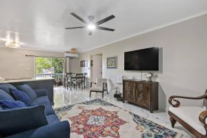 a living room with a blue couch and a flat screen tv at Newly Renovated Condo in Christiansted