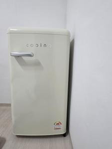 a white refrigerator sitting on top of a floor at Dear, U in Gyeongju +50 photos
