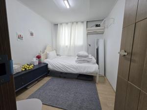 a small bedroom with a bed and a window at Dear, U in Gyeongju