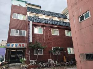 a red brick building with bikes parked in front of it at Dear, U in Gyeongju