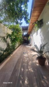 a hallway of a house with plants on it at Pousada Guarujá, suítes Praia do tombo in Guarujá +21 photos