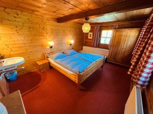 a bedroom with a bed and a sink in a room at Ferienhaus Unterkircher-Wallner in Heiligenblut