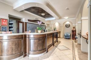 a kitchen with a large wooden bar in a room at Hotel Villa Ambrosina in Impruneta