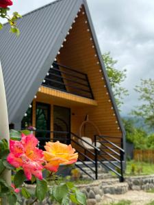 a house with a roof with flowers in front of it at NerNeri Cottage Martvili in Martvili