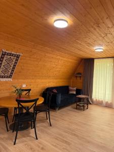 a living room with a couch and a table at NerNeri Cottage Martvili in Martvili