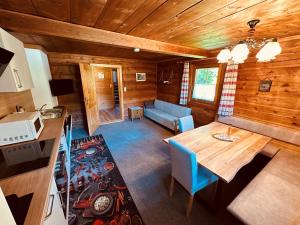 a living room with a table and a couch in a cabin at Ferienhaus Unterkircher-Wallner in Heiligenblut