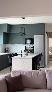 a living room with a couch and a kitchen at Nayra View & Spa in Kavála