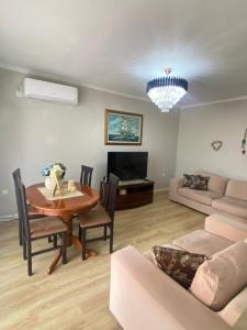a living room with a table and a couch at Himara City-Center Apartment in Himare