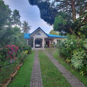 a house with a driveway in front of it at Mamita Seaside Resort in Guinisiliban