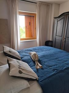 a bed with a hat on it with a window at Vila Pan in Zadar +55 photos