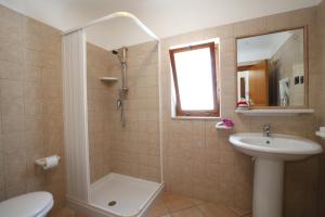 a bathroom with a shower toilet and a sink at Baia Di Campi in Vieste