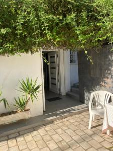 a door leading to a patio with a chair and plants at Beau Rez de Jardin in Ariana +2 photos