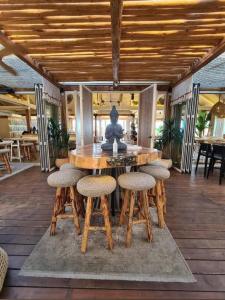 a large wooden table with chairs and a fountain at BmB apartments in Paralia Katerinis