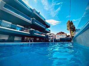 a view of a swimming pool in front of a building at BmB apartments in Paralia Katerinis