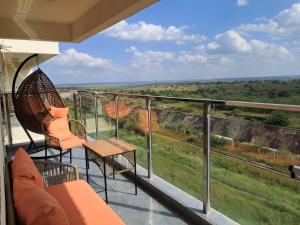 a balcony with chairs and a table and a view at Favorite Staycation by Janice - Modern Comfort Near Airport in Nairobi