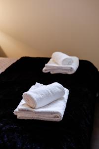 two towels sitting on top of a black blanket at Olive and Sea Suites in Kalamata +40 photos