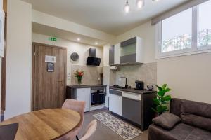 a kitchen and living room with a table and a couch at Olive and Sea Suites in Kalamata
