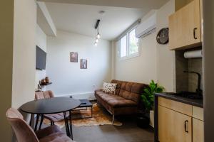 a living room with a couch and a table at Olive and Sea Suites in Kalamata