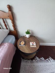 a table with a plant on it next to a bed at Fishing in Foxford