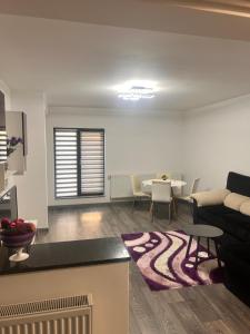 a living room with a couch and a table at D&D New Residence in Piteşti