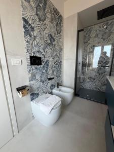 a bathroom with a toilet and a sink at 7 LAKES Aparthotel in Burolo +66 photos
