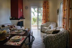 a living room with a couch a table and a chair at Beach Residence Walk to Beach Garden - Parking in Chalkida