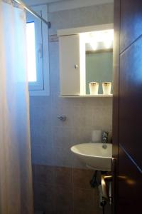 a bathroom with a sink and a mirror at Beach Residence Walk to Beach Garden - Parking in Chalkida +24 photos
