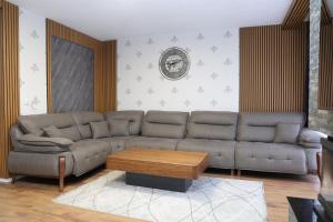 a living room with a couch and a coffee table at Sharr Mount in Prizren