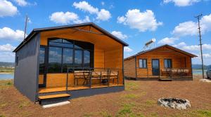 a tiny house with a large window on a field at Tsovazard Lake House in Tsovazard +9 photos