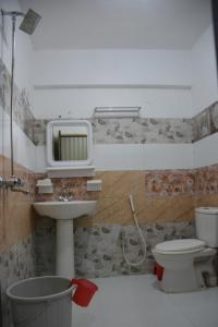 a bathroom with a sink and a toilet at Pine Hills, Naran in Naran