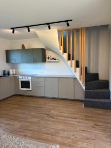a kitchen with a staircase in a house at Tavo Jūros Namai in Palanga