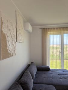 a living room with a couch and a map on the wall at Tavo Jūros Namai in Palanga