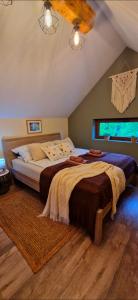 a bedroom with a large bed in a room at Domek na Folwarku z jacuzzi in Tarnawa Dolna +30 photos