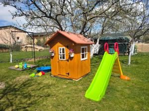 a small house with a slide and a playground at Apartments Ľubka in Zuberec