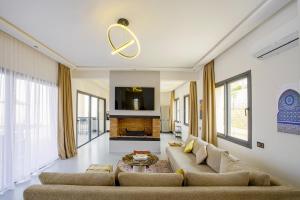 a living room with a couch and a fireplace at Villa Ines with heated pool & panoramic views in El Aïn