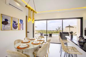 a kitchen and dining room with a table and chairs at Villa Ines with heated pool & panoramic views in El Aïn +41 photos