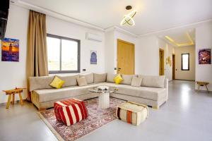 a living room with a couch and a table at Villa Ines with heated pool & panoramic views in El Aïn
